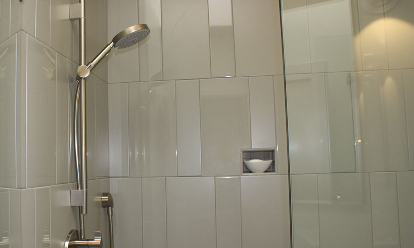 Hand-held showerhead in bathroom